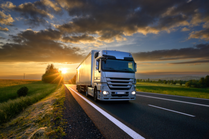 Truck on highway sunset